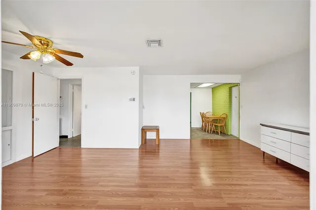 a view of empty room with wooden floor