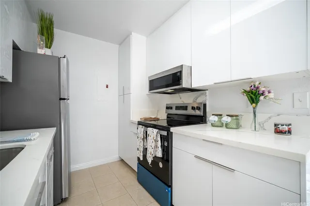 a kitchen with a sink a stove and a refrigerator