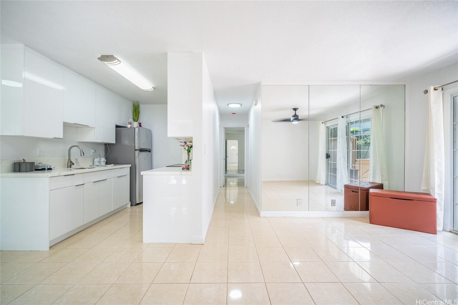 625 Mananai Place, Unit 24A Honolulu, HI 96818 - Photo 4 of 18 a large white kitchen with cabinets and a large window