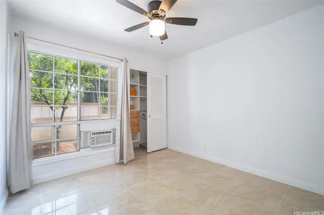 a view of empty room with ceiling fan