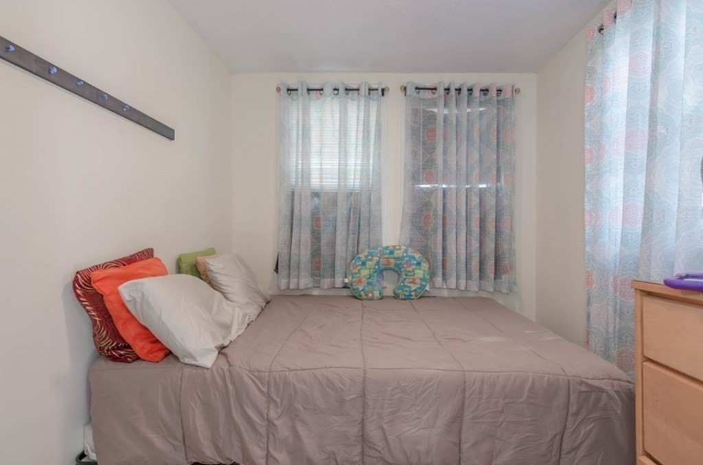 58 Lake Street Lawrence, MA 01841 - Photo 14 of 26 a bedroom with a bed and a chair