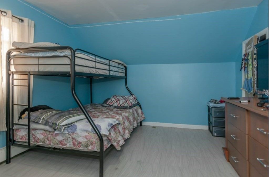 58 Lake Street Lawrence, MA 01841 - Photo 16 of 26 a bedroom with a bed and a mirror