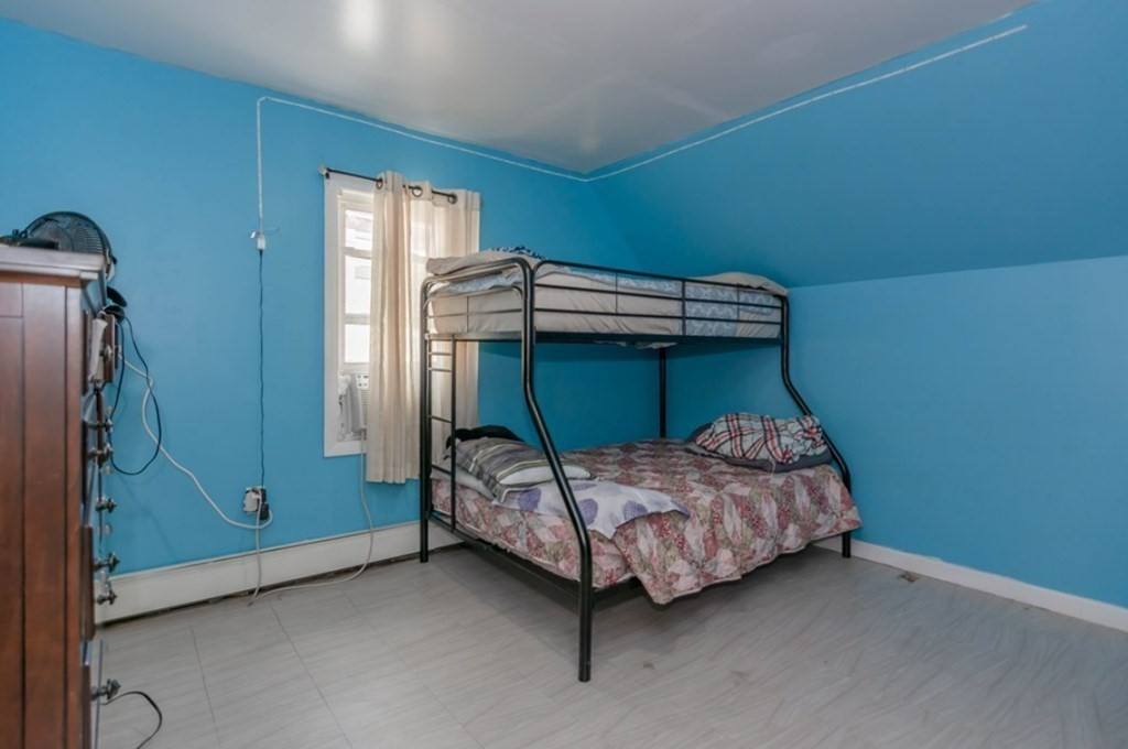 58 Lake Street Lawrence, MA 01841 - Photo 17 of 26 a bedroom with a bed and a window