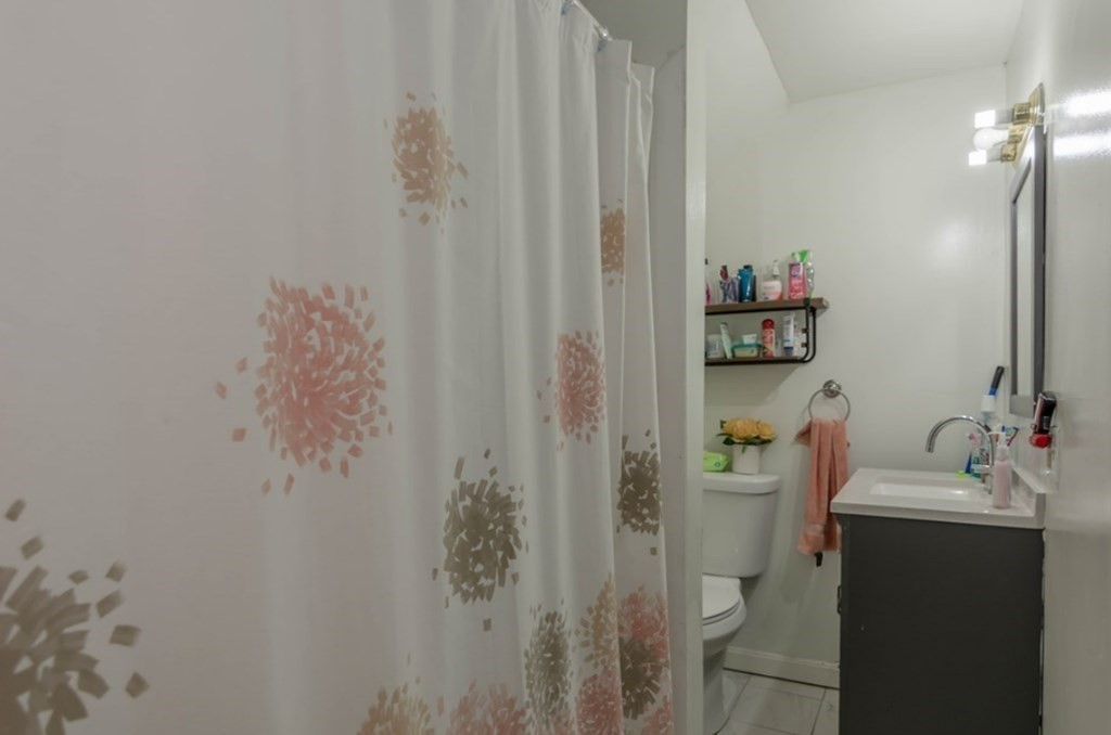 58 Lake Street Lawrence, MA 01841 - Photo 19 of 26 a bathroom with a sink and a mirror