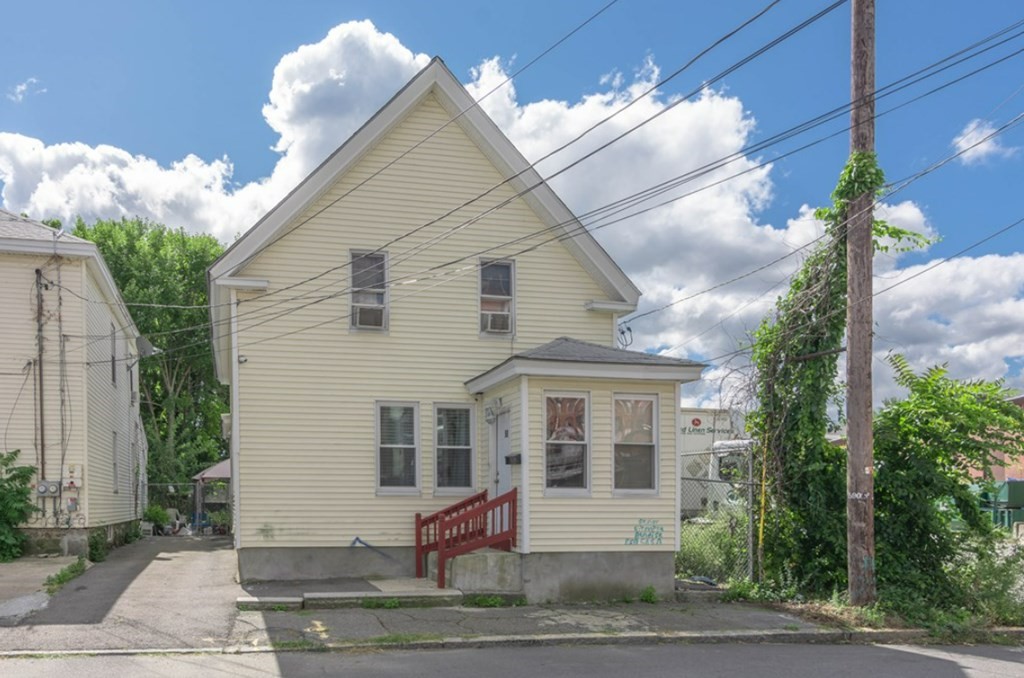 58 Lake Street Lawrence, MA 01841 - Photo 2 of 26 a front view of a house with a yard