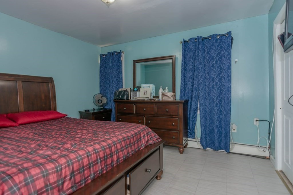 58 Lake Street Lawrence, MA 01841 - Photo 21 of 26 a bedroom with a bed and a dresser