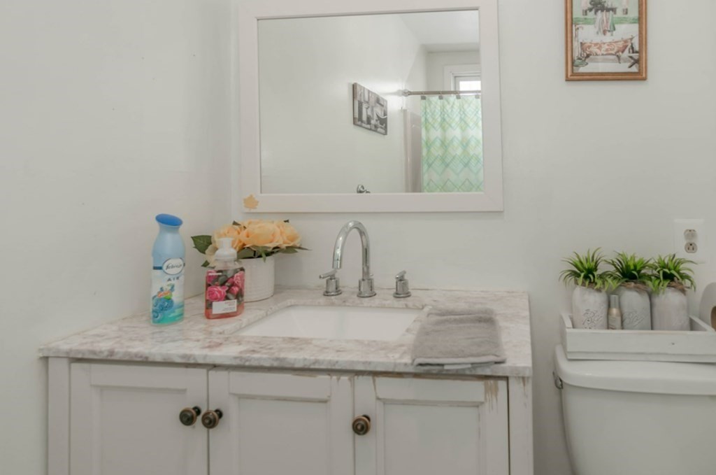 58 Lake Street Lawrence, MA 01841 - Photo 22 of 26 a bathroom with a granite countertop sink and a mirror