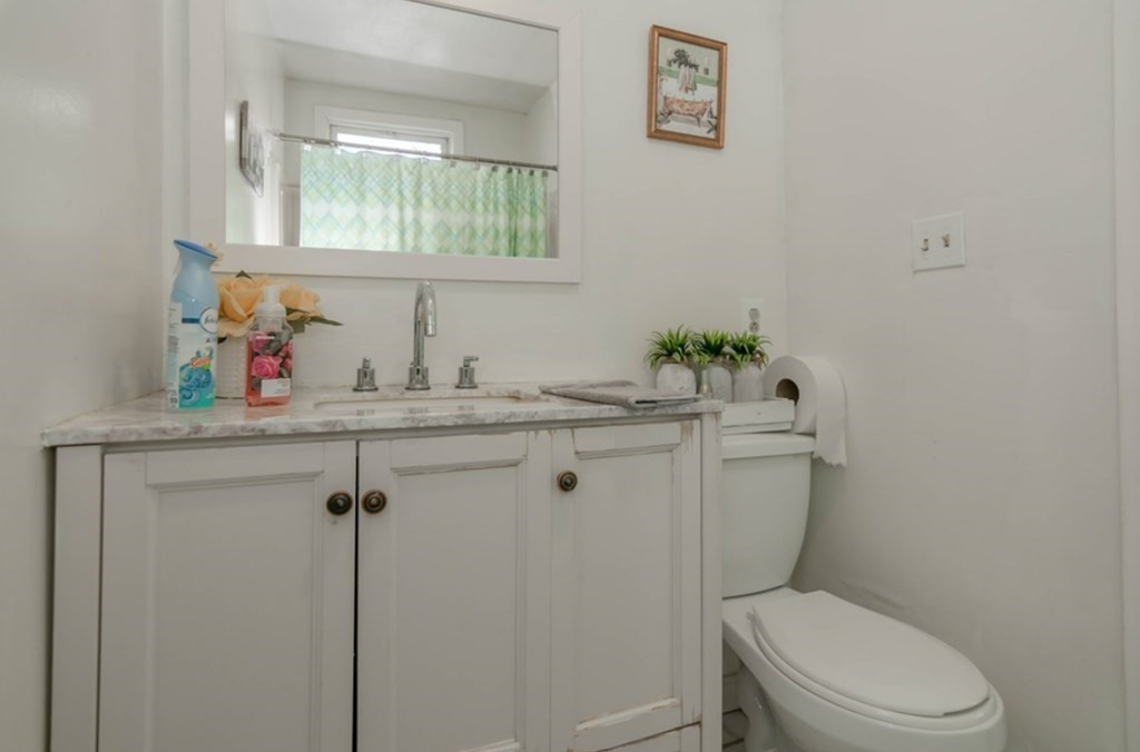 58 Lake Street Lawrence, MA 01841 - Photo 23 of 26 a bathroom with a granite countertop toilet sink and mirror
