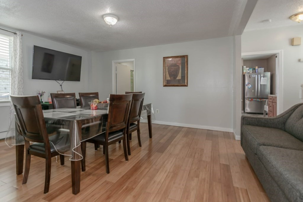 58 Lake Street Lawrence, MA 01841 - Photo 8 of 26 a dining room with furniture and wooden floor