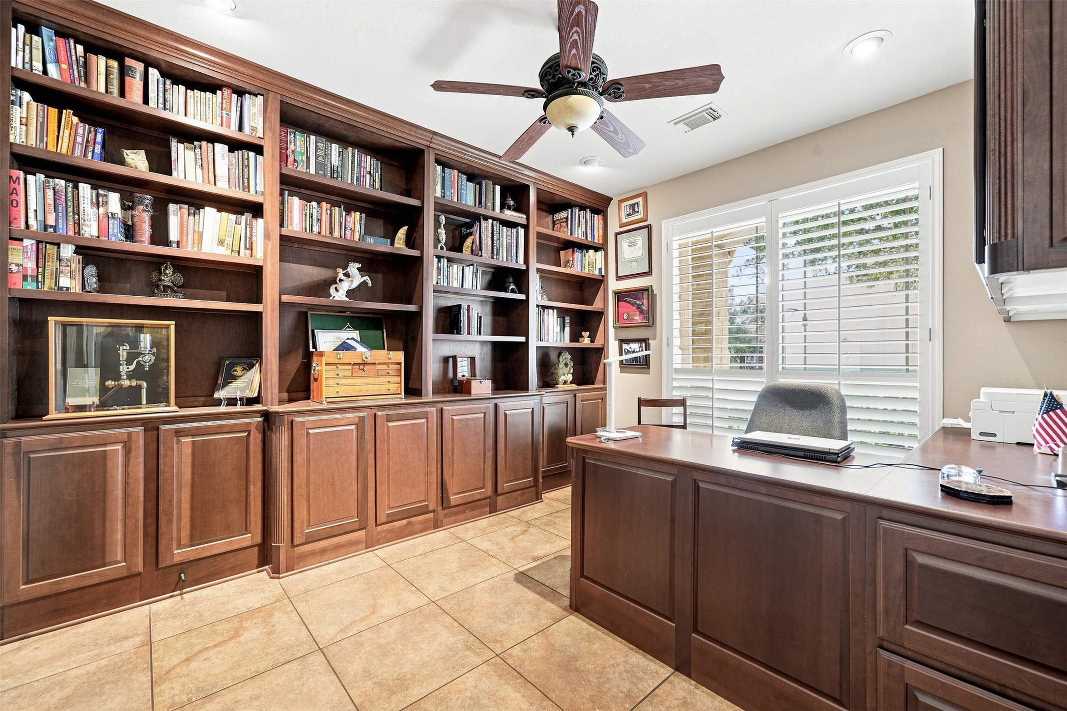 402 Ridgetop Bend Cedar Park, TX 78613 - Photo 6 of 40 Rich wood built-in bookcases and tile flooring define this quiet home office space.