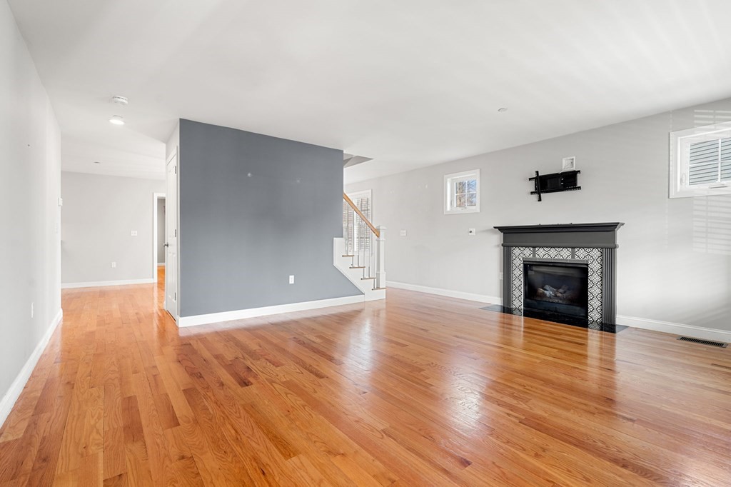 8 Comanche Circle, Unit 4 Haverhill, MA 01835 - Photo 15 of 19 a view of a livingroom with wooden floor and a fireplace