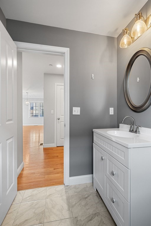 8 Comanche Circle, Unit 4 Haverhill, MA 01835 - Photo 17 of 19 a bathroom with a granite countertop sink a mirror and a