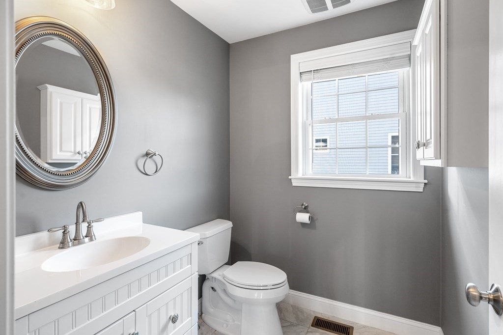 8 Comanche Circle, Unit 4 Haverhill, MA 01835 - Photo 18 of 19 a bathroom with a toilet a sink and a mirror