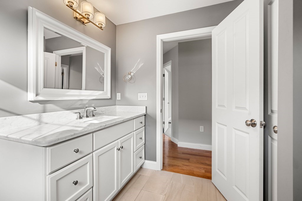 8 Comanche Circle, Unit 4 Haverhill, MA 01835 - Photo 10 of 19 a bathroom with a sink double vanity and a mirror