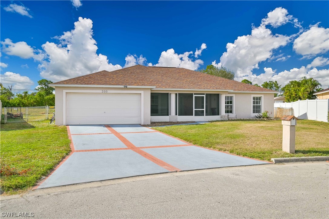 200 Roat Street Lehigh Acres, FL 33936 - Photo 1 of 35 a view of a house with a backyard