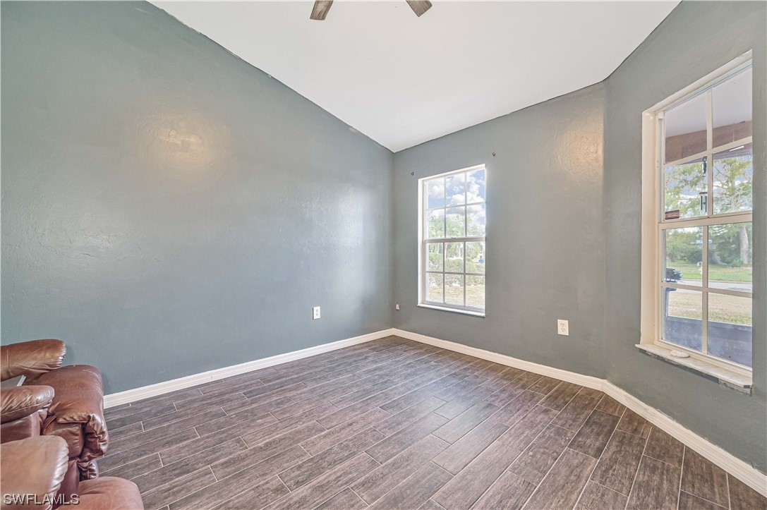 200 Roat Street Lehigh Acres, FL 33936 - Photo 24 of 35 a view of room with window and wooden floor