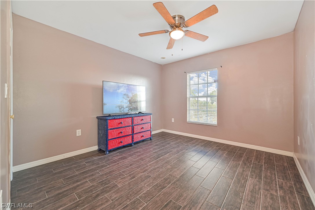 200 Roat Street Lehigh Acres, FL 33936 - Photo 25 of 35 an empty room with windows and ceiling fan