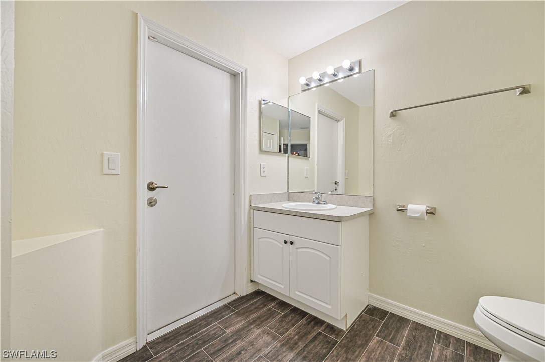 200 Roat Street Lehigh Acres, FL 33936 - Photo 27 of 35 a bathroom with a sink and a mirror