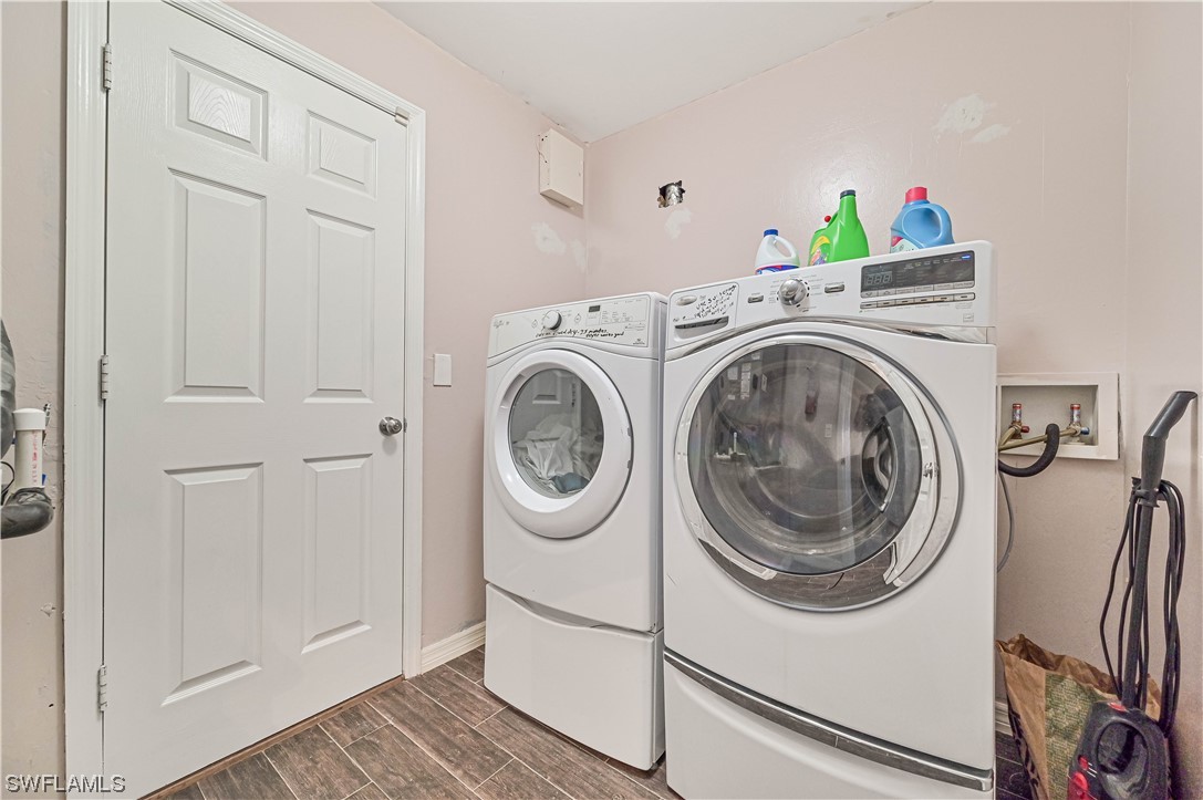 200 Roat Street Lehigh Acres, FL 33936 - Photo 31 of 35 a utility room with dryer and washer