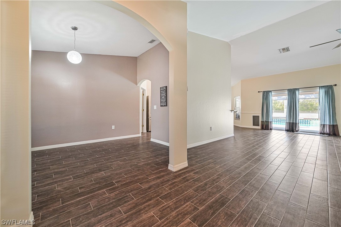 200 Roat Street Lehigh Acres, FL 33936 - Photo 5 of 35 a view of a livingroom with wooden floor