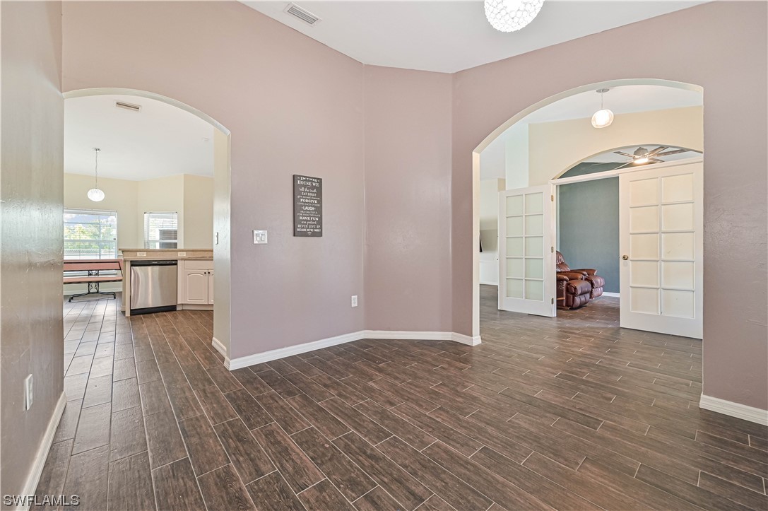 200 Roat Street Lehigh Acres, FL 33936 - Photo 6 of 35 wooden floor in a room with a large window
