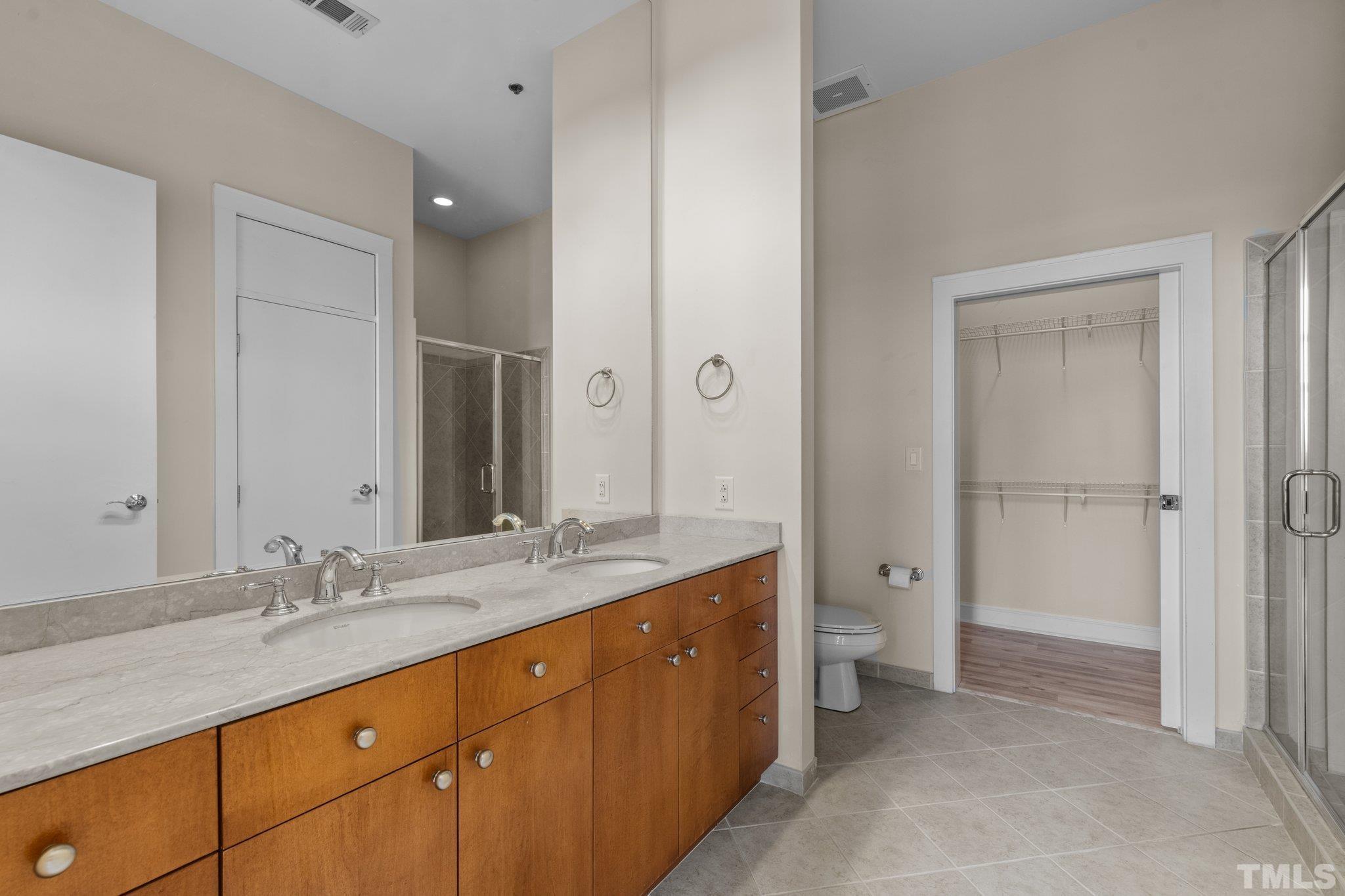 618 North Boylan Avenue, Unit 1032 Raleigh, NC 27603 - Photo 19 of 69 a spacious bathroom with a granite countertop sink mirror and a toilet
