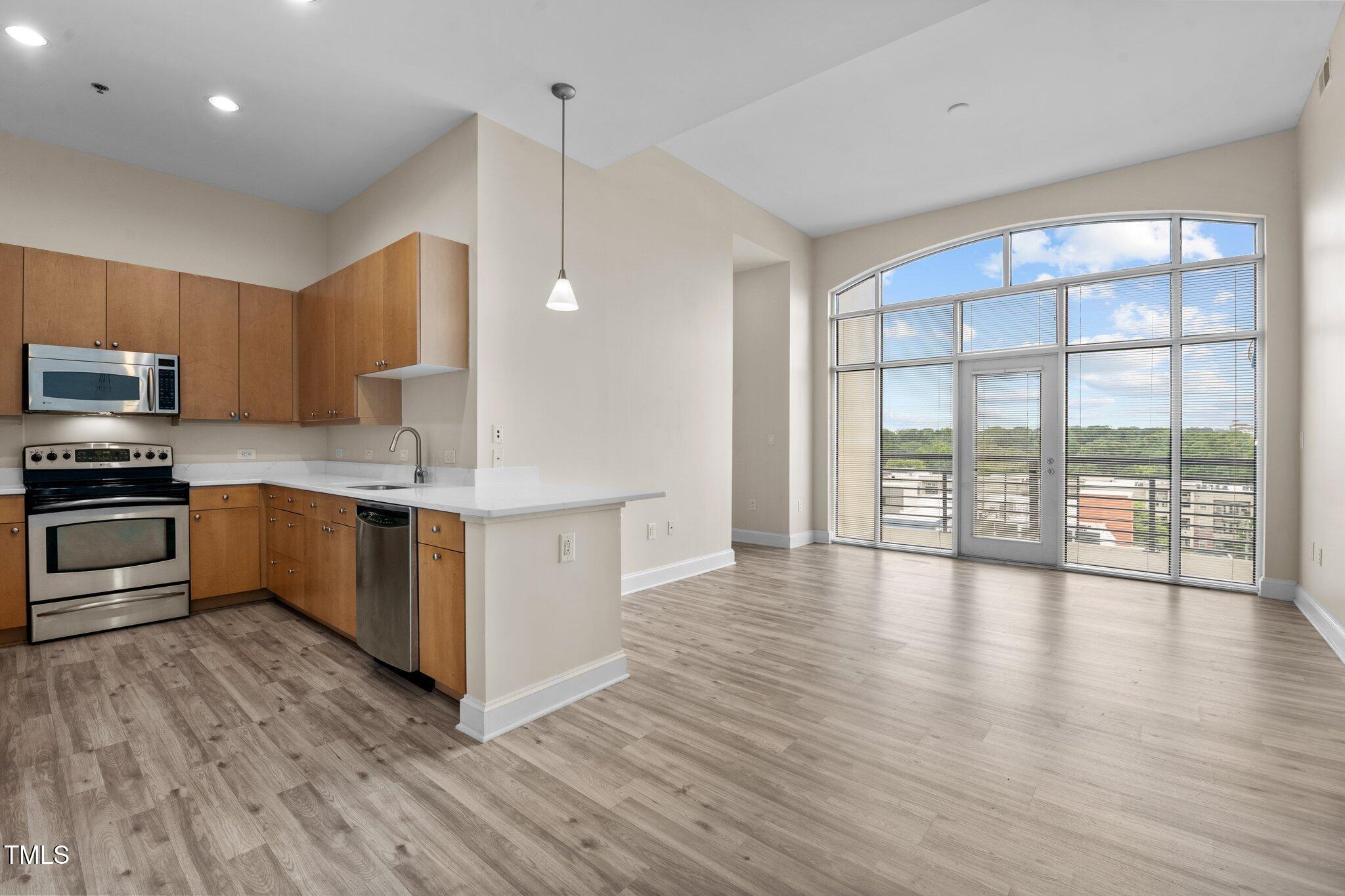 618 North Boylan Avenue, Unit 1032 Raleigh, NC 27603 - Photo 2 of 69 a kitchen with stainless steel appliances a stove top oven a sink a refrigerator with wooden floors and cabinets