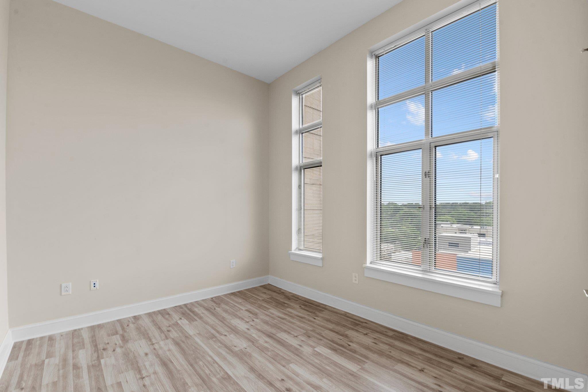 618 North Boylan Avenue, Unit 1032 Raleigh, NC 27603 - Photo 23 of 69 a view of an empty room with wooden floor and a window