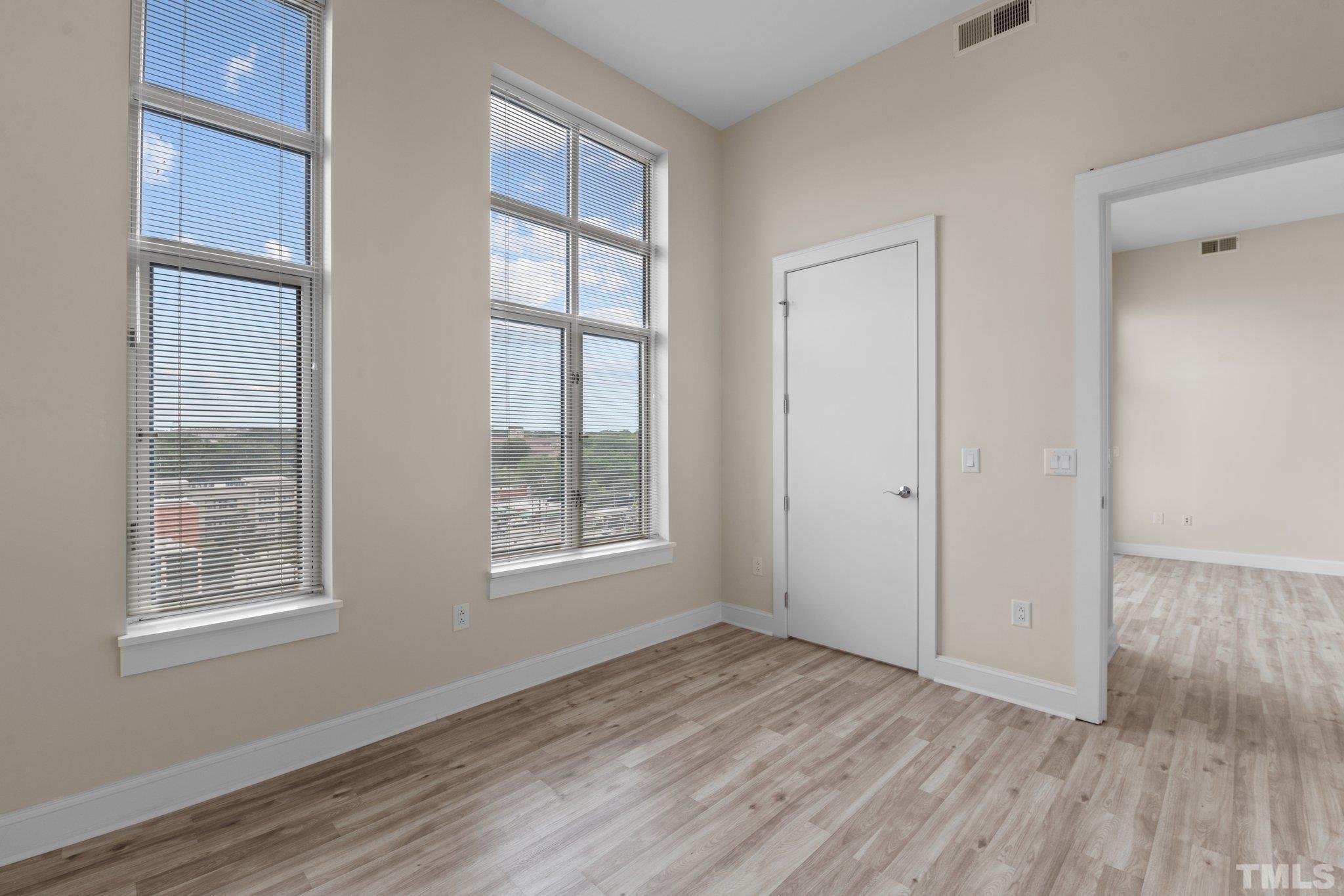 618 North Boylan Avenue, Unit 1032 Raleigh, NC 27603 - Photo 24 of 69 an empty room with wooden floor and windows