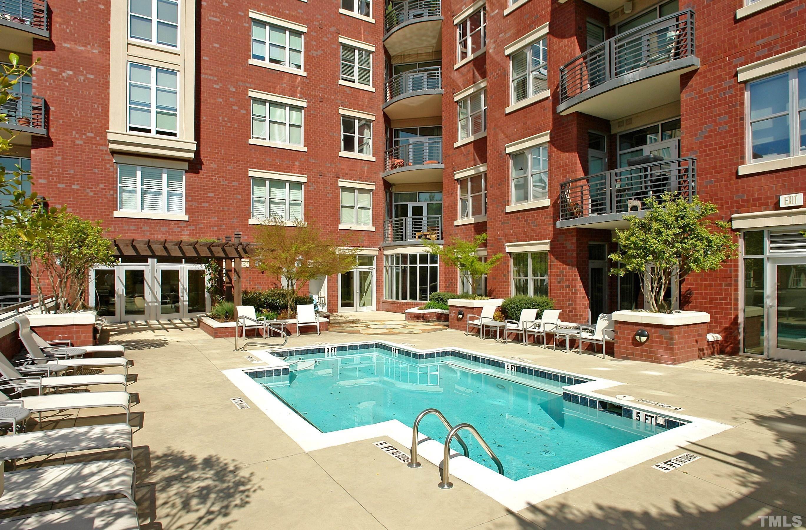 618 North Boylan Avenue, Unit 1032 Raleigh, NC 27603 - Photo 30 of 69 a view of a swimming pool with a lounge chairs