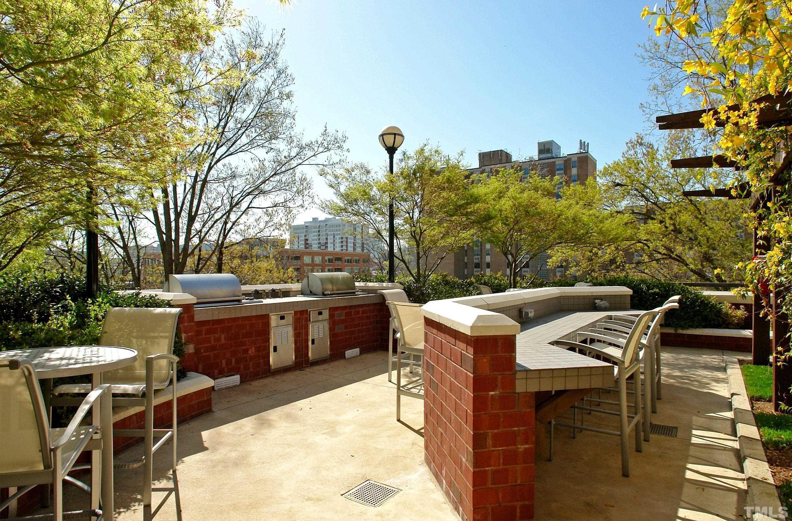 618 North Boylan Avenue, Unit 1032 Raleigh, NC 27603 - Photo 33 of 69 a view of a dinning table and chairs in the terrace