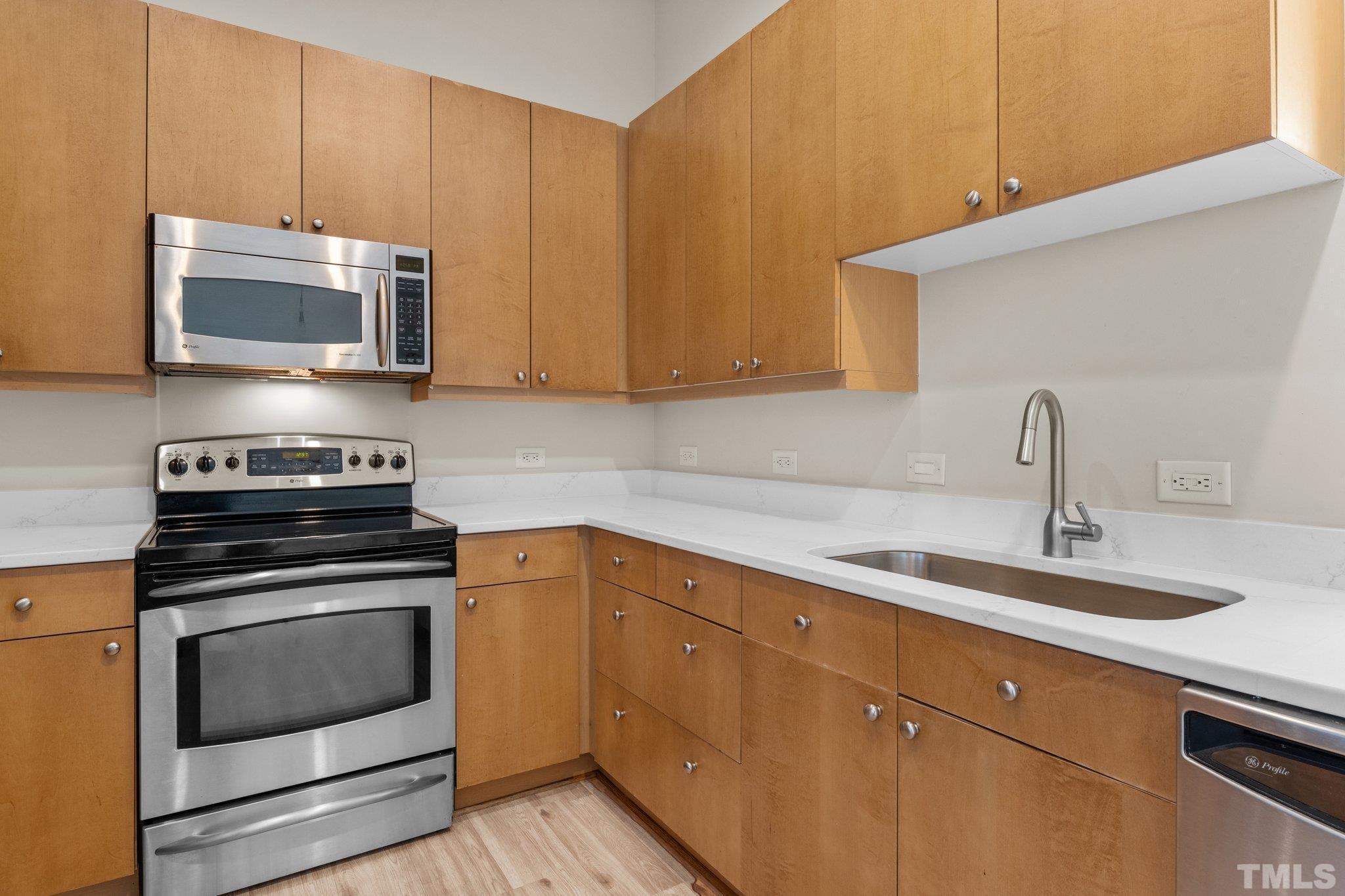 618 North Boylan Avenue, Unit 1032 Raleigh, NC 27603 - Photo 5 of 69 a kitchen with stainless steel appliances granite countertop a sink a stove and microwave