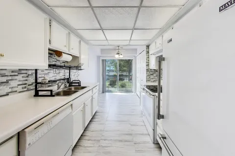 a kitchen with stainless steel appliances granite countertop a stove and a refrigerator