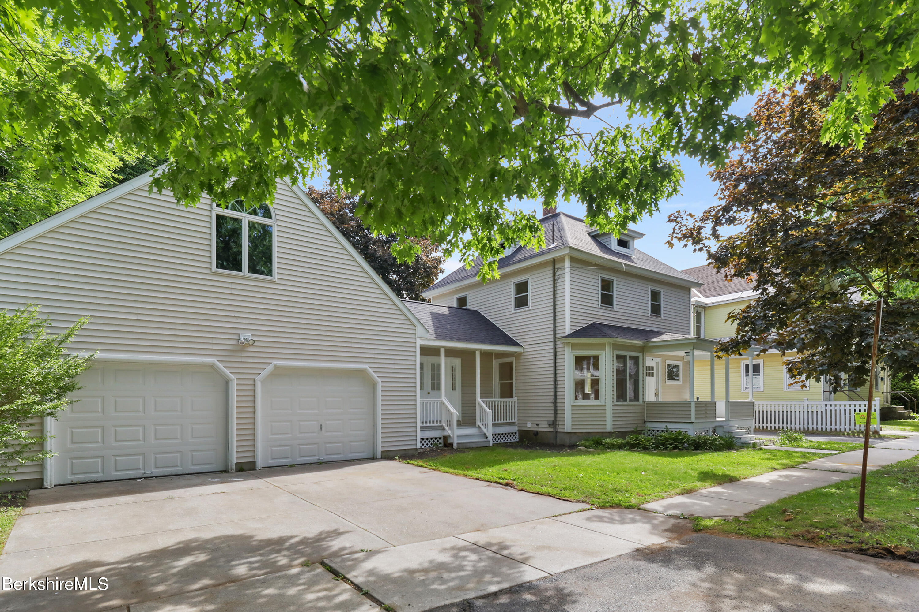 99 Lyman Street Pittsfield, MA 01201 - Photo 1 of 38 a front view of a house with a yard and garage