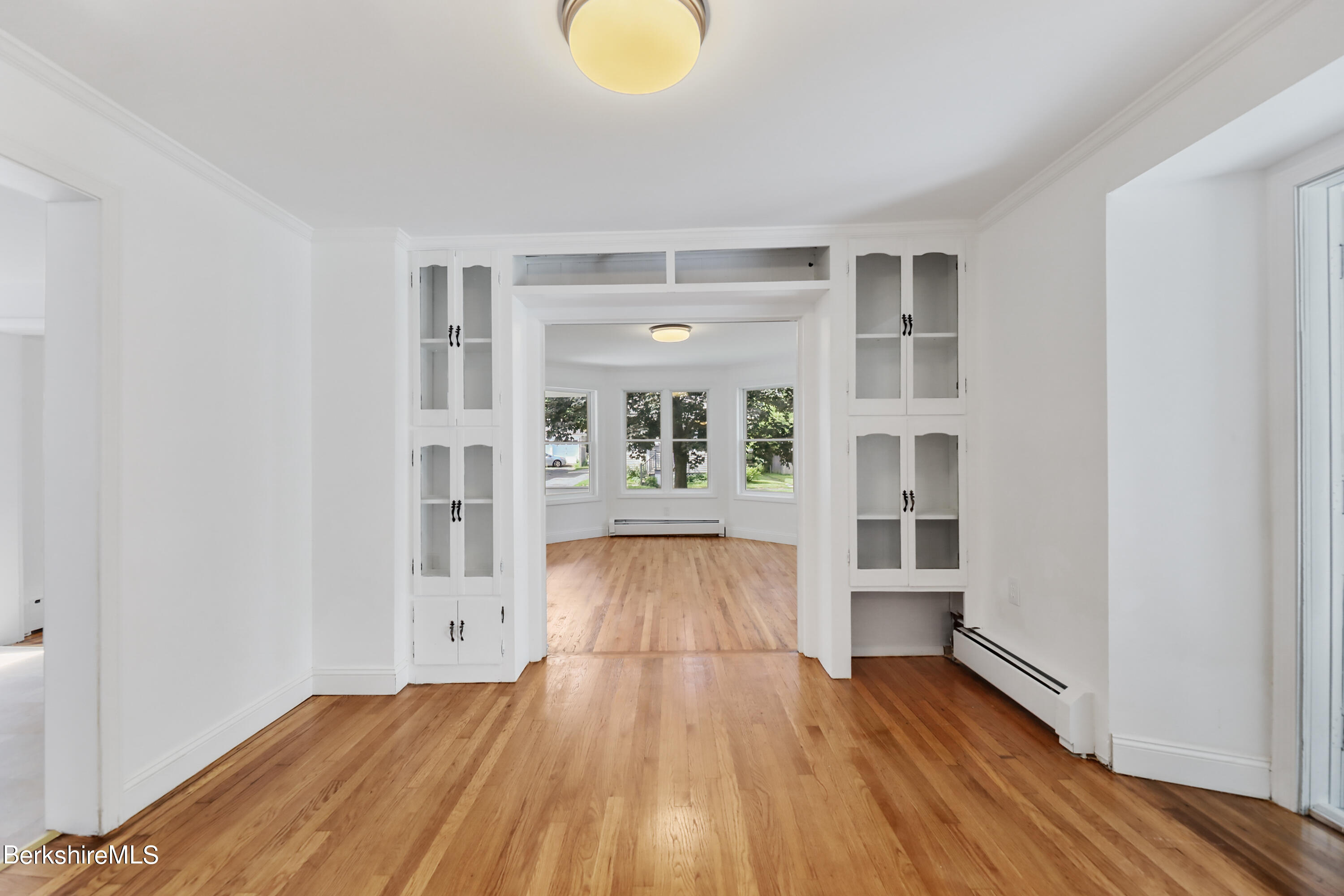 99 Lyman Street Pittsfield, MA 01201 - Photo 11 of 38 wooden floor in an empty room with a window