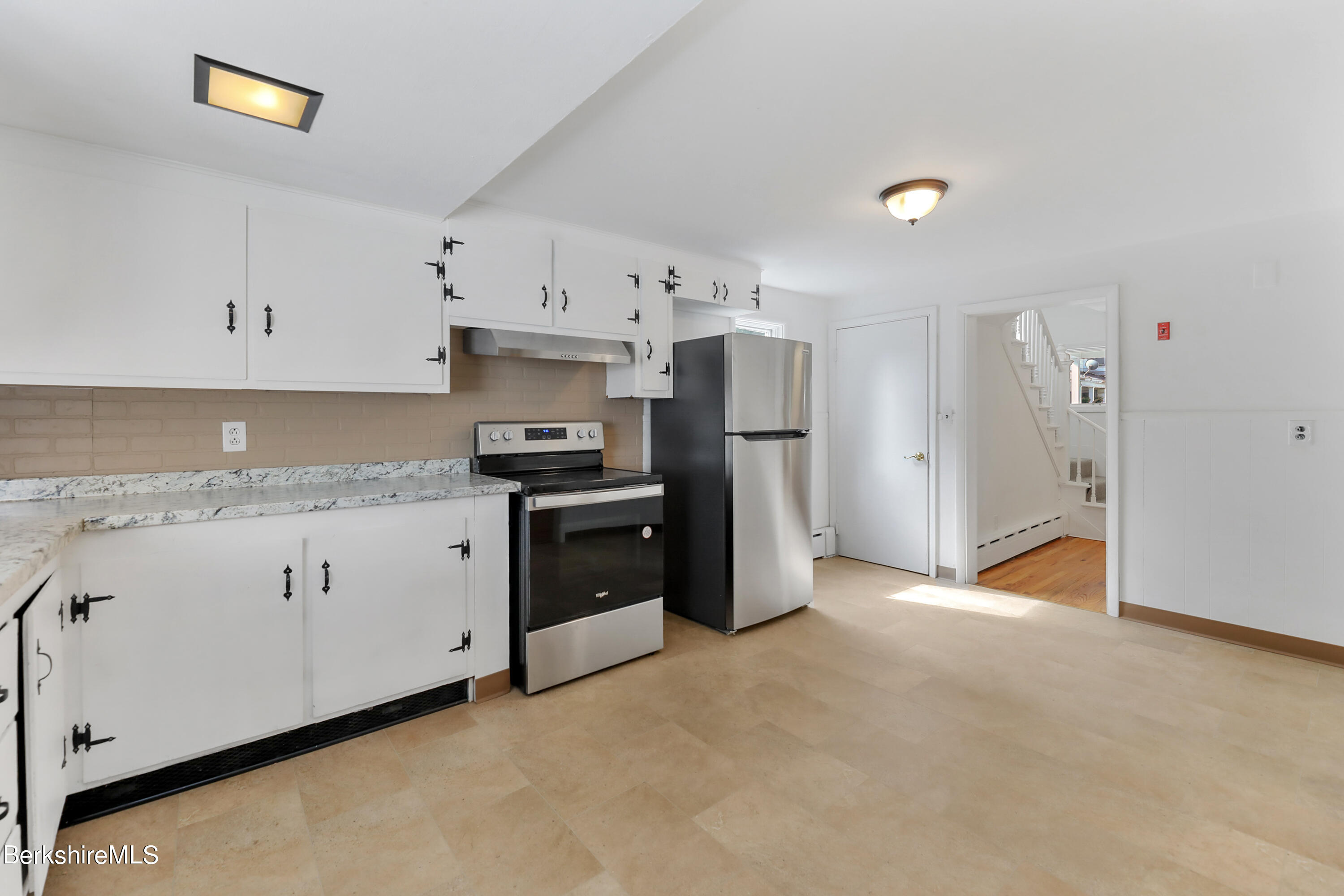 99 Lyman Street Pittsfield, MA 01201 - Photo 14 of 38 a kitchen with stainless steel appliances granite countertop a refrigerator and a stove top oven