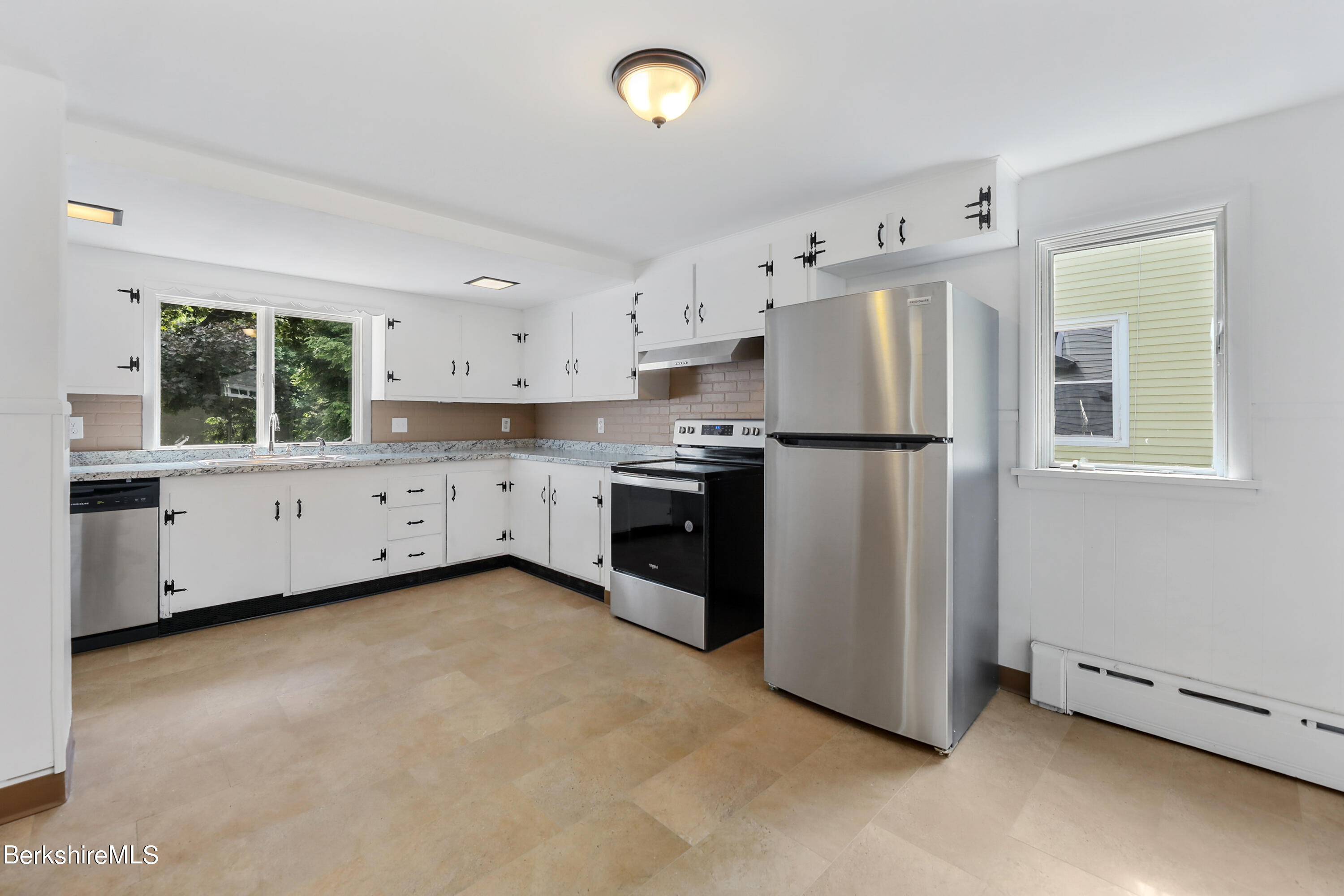 99 Lyman Street Pittsfield, MA 01201 - Photo 15 of 38 a kitchen with stainless steel appliances a refrigerator sink and cabinets