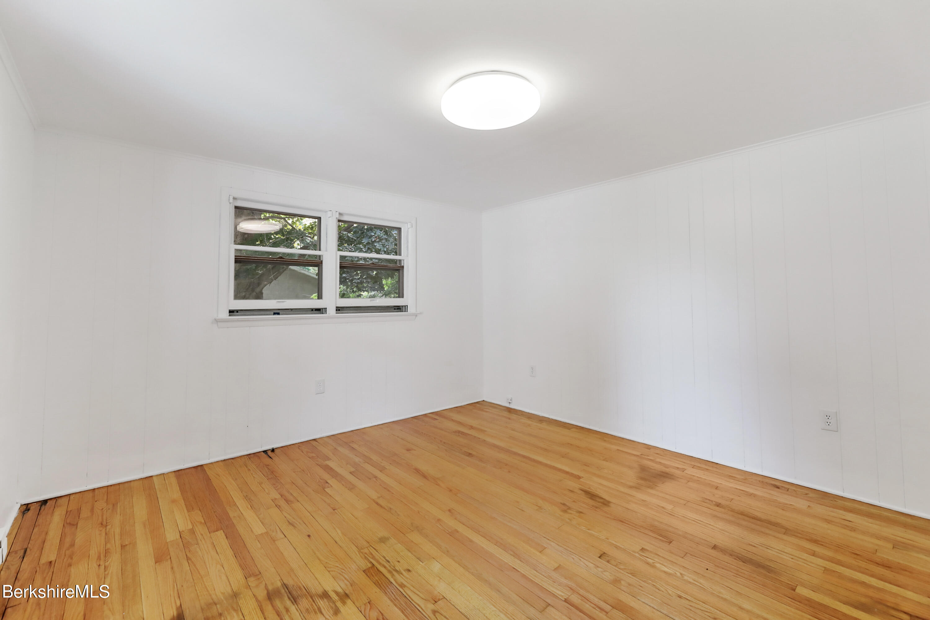 99 Lyman Street Pittsfield, MA 01201 - Photo 17 of 38 a view of empty room with wooden floor and fan