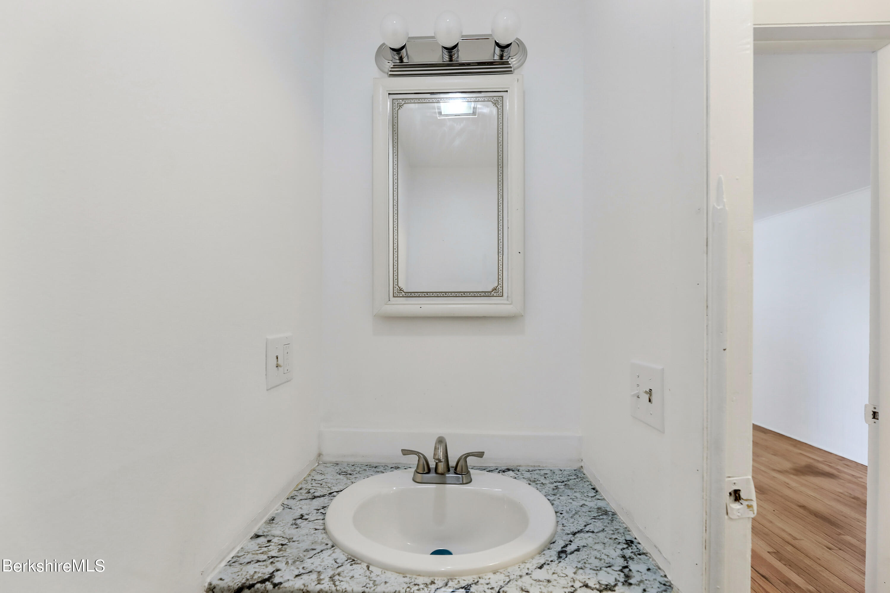 99 Lyman Street Pittsfield, MA 01201 - Photo 19 of 38 a bathroom with a sink and a mirror