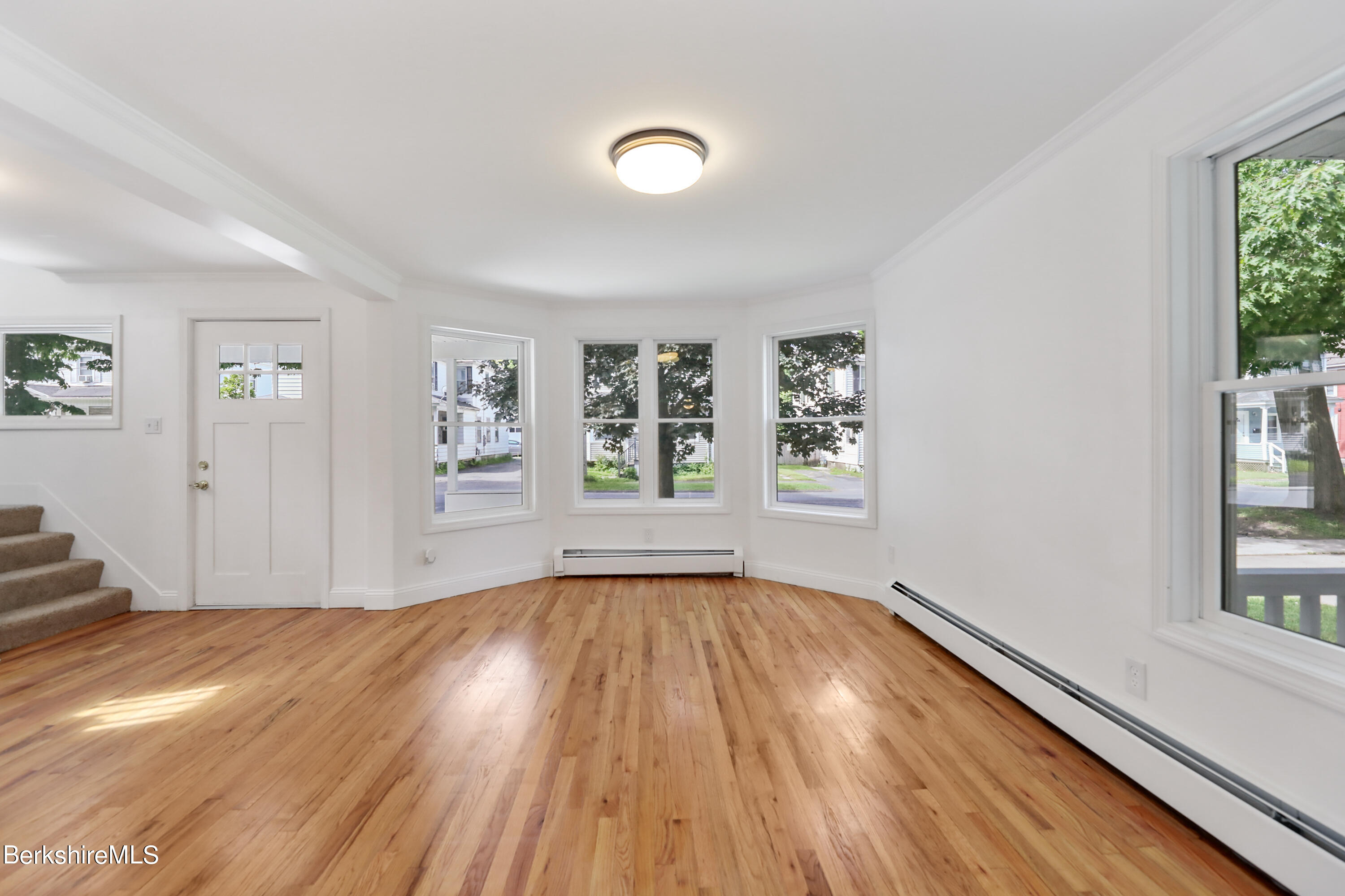 99 Lyman Street Pittsfield, MA 01201 - Photo 7 of 38 wooden floor in an empty room with a window