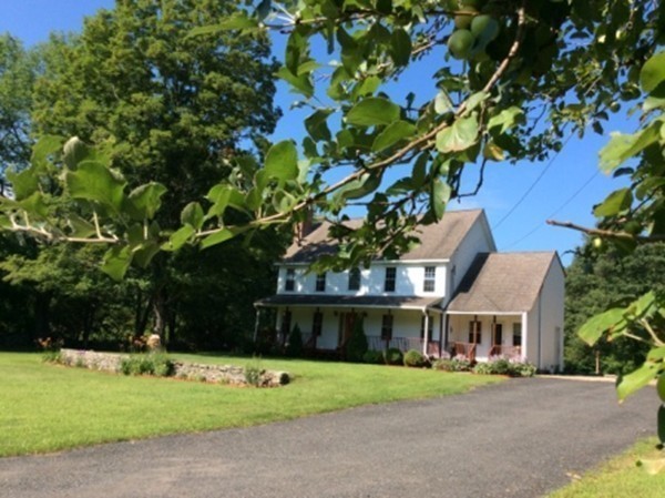1376 Patrill Hollow Road Hardwick, MA 01082 - Photo 1 of 16 a front view of a house with a garden
