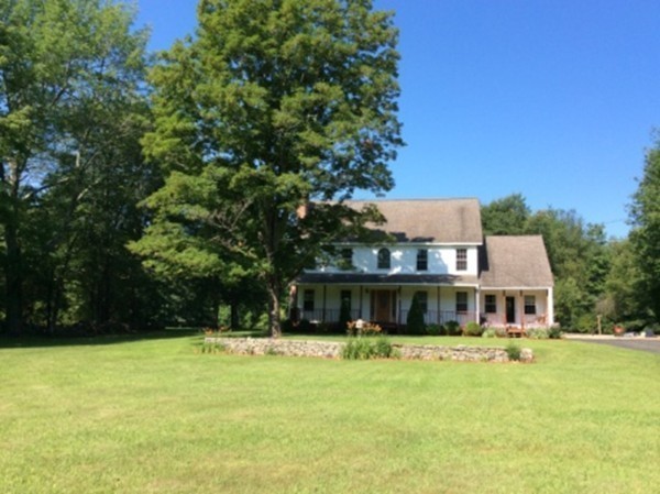 1376 Patrill Hollow Road Hardwick, MA 01082 - Photo 2 of 16 a front view of a house with a yard