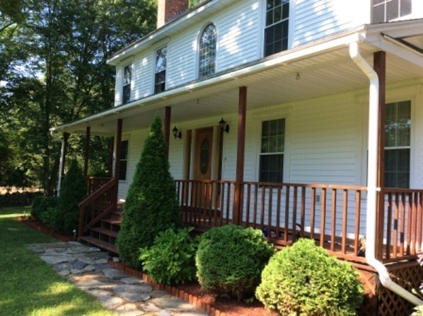 1376 Patrill Hollow Road Hardwick, MA 01082 - Photo 4 of 16 a view of a house with a flower garden