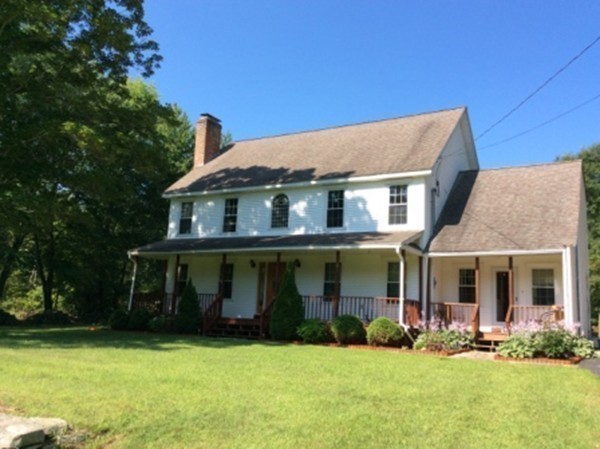 1376 Patrill Hollow Road Hardwick, MA 01082 - Photo 5 of 16 a front view of a house with a yard and trees