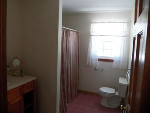 1376 Patrill Hollow Road Hardwick, MA 01082 - Photo 9 of 16 a bathroom with a toilet a sink a window and mirror