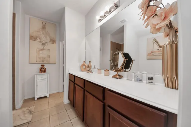 a bathroom with a double vanity sink a mirror and a bathtub