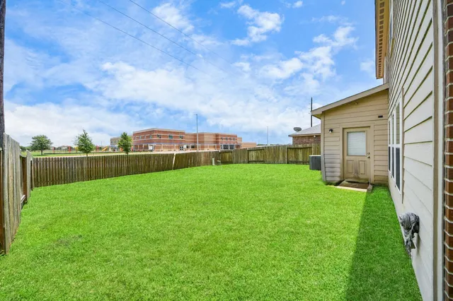 a view of yard with swimming pool and green space