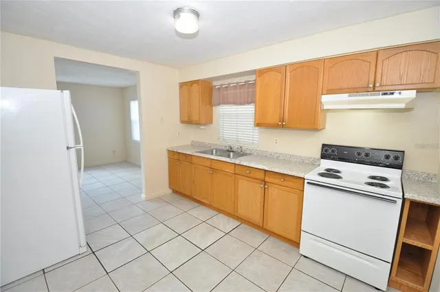 a kitchen with a stove top oven sink and cabinets
