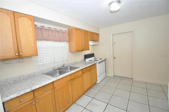 a kitchen with stainless steel appliances granite countertop a sink and a white cabinets