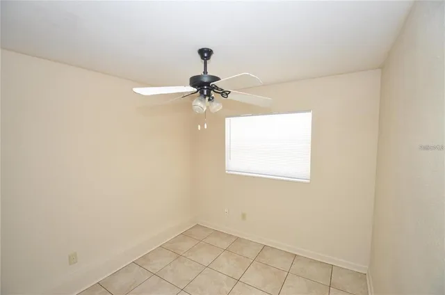 a view of a room with a ceiling fan and a window